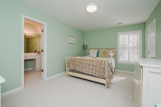 carpeted bedroom with ensuite bathroom