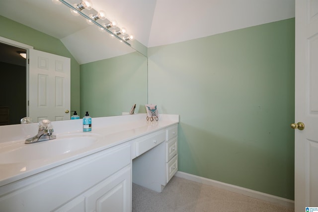 bathroom with vanity and lofted ceiling