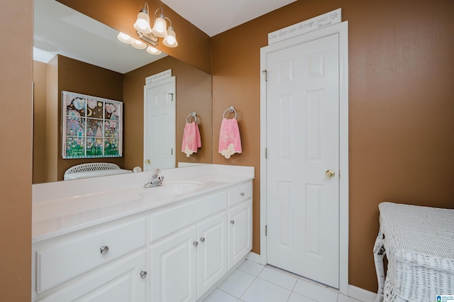 bathroom with tile patterned floors, vanity, and a notable chandelier