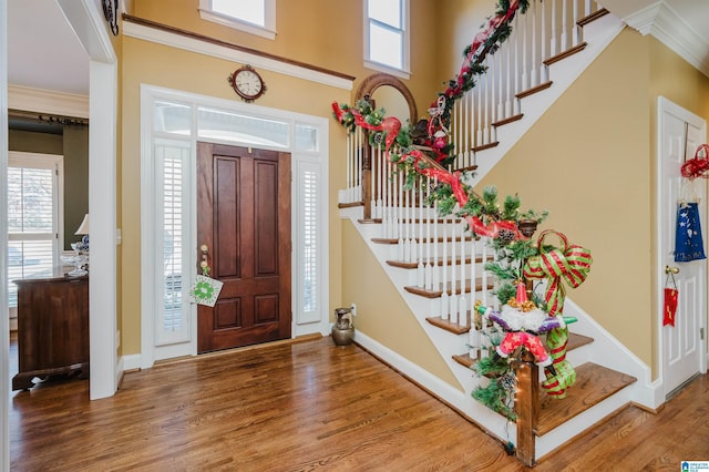 entryway featuring ornamental molding and hardwood / wood-style flooring