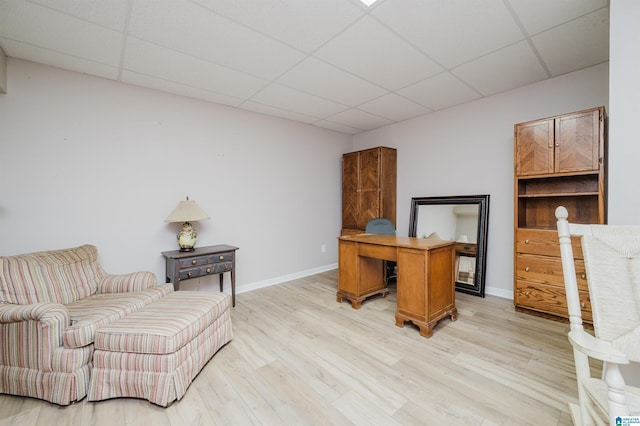 office featuring light wood-type flooring and a drop ceiling