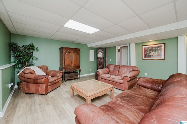 living room featuring a paneled ceiling and light hardwood / wood-style flooring