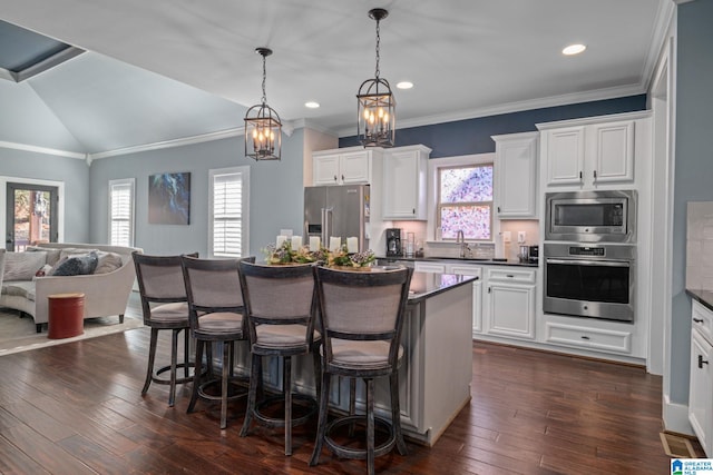 kitchen featuring appliances with stainless steel finishes, dark hardwood / wood-style flooring, white cabinetry, and sink