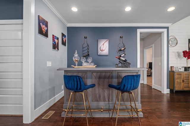 bar featuring dark wood-type flooring and ornamental molding