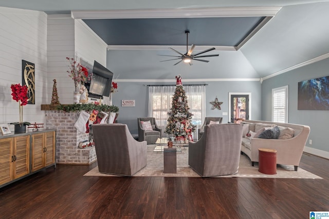 living room with lofted ceiling, crown molding, ceiling fan, and dark wood-type flooring