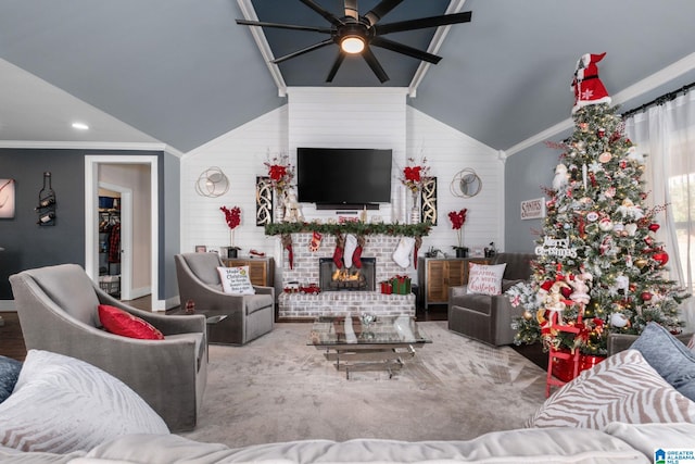 living room featuring a brick fireplace, vaulted ceiling, ceiling fan, and ornamental molding