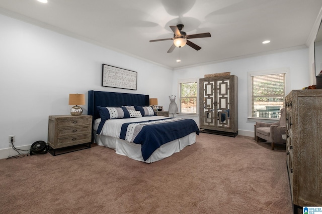 carpeted bedroom with multiple windows, ornamental molding, and ceiling fan