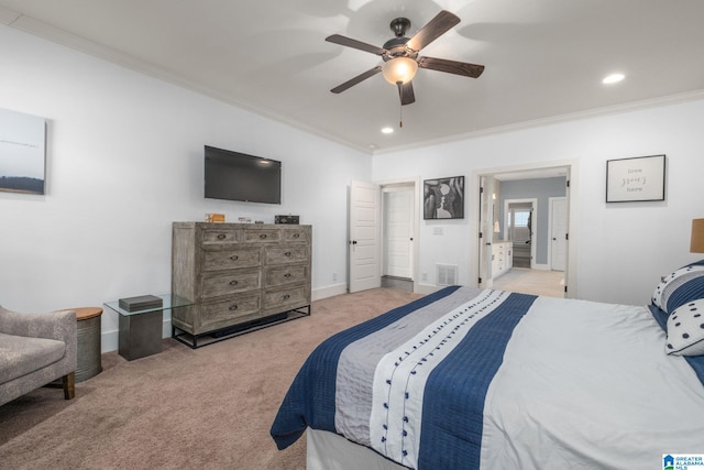 carpeted bedroom with connected bathroom, ceiling fan, and crown molding