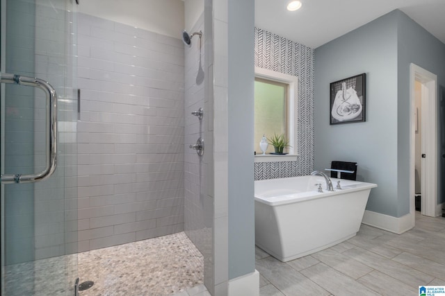 bathroom featuring separate shower and tub