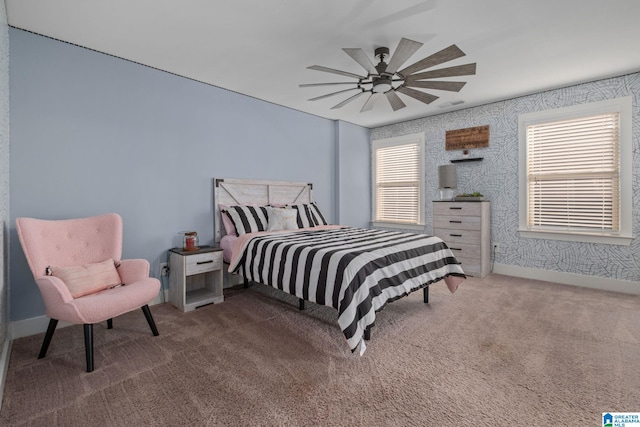 bedroom featuring ceiling fan, carpet floors, and multiple windows