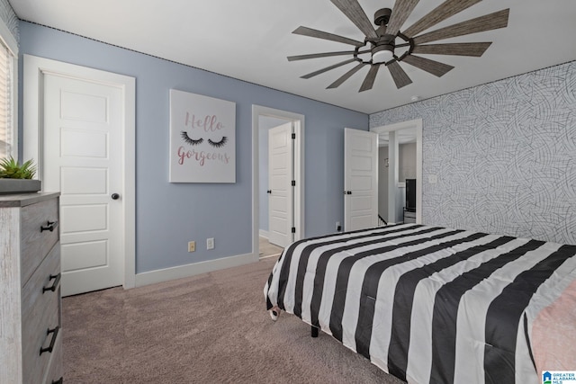 carpeted bedroom featuring ceiling fan and ensuite bathroom