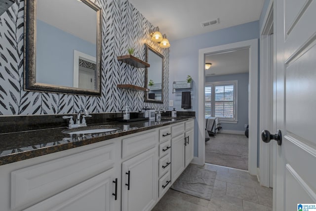 bathroom with tile patterned floors and vanity