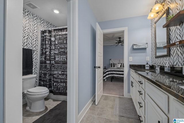 bathroom with tile patterned floors, walk in shower, vanity, ceiling fan, and toilet