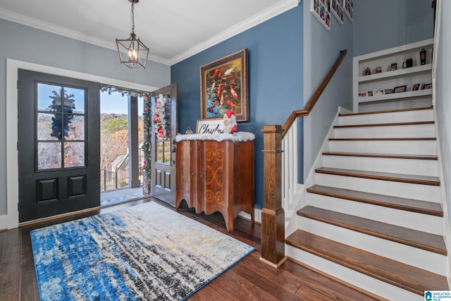 foyer entrance featuring crown molding, dark hardwood / wood-style flooring, and a notable chandelier