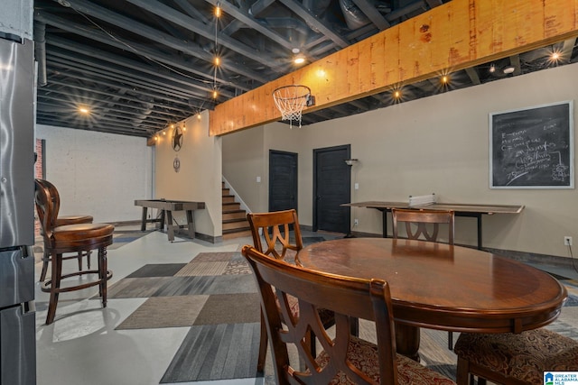 dining space featuring concrete flooring