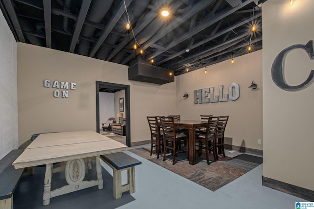 dining space featuring concrete flooring