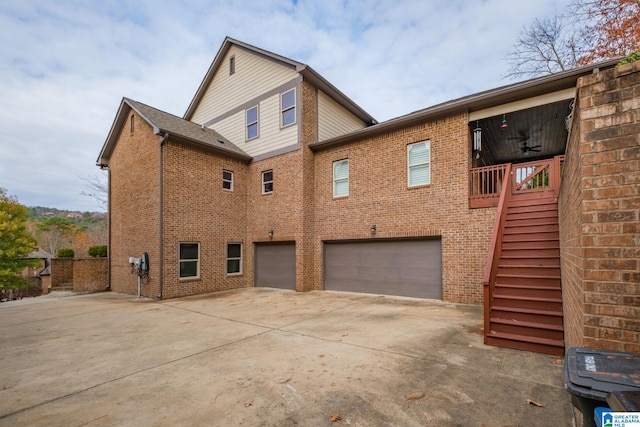 back of house featuring ceiling fan and a garage