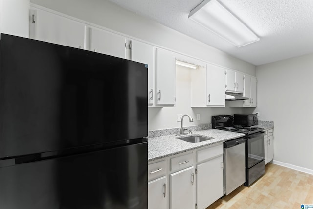 kitchen featuring white cabinetry, sink, light stone counters, light hardwood / wood-style flooring, and black appliances