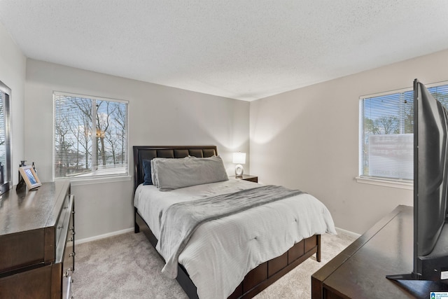 carpeted bedroom featuring a textured ceiling