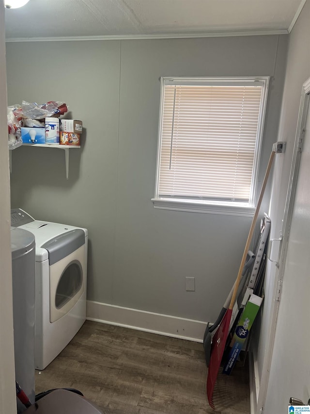 washroom featuring wood-type flooring, crown molding, and washing machine and clothes dryer