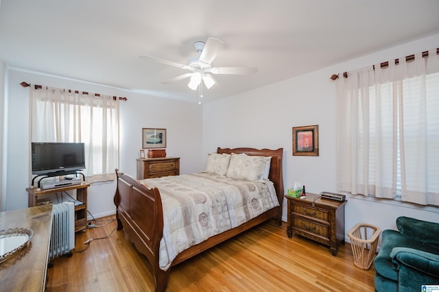 bedroom featuring light wood-type flooring and ceiling fan