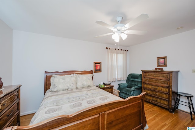 bedroom with ceiling fan and light hardwood / wood-style flooring