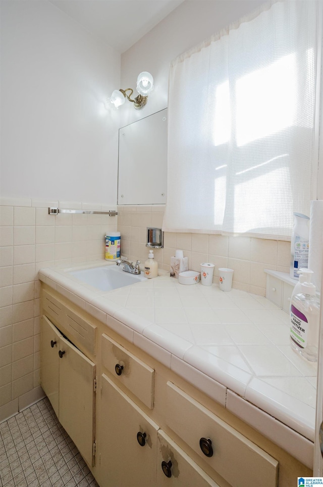 bathroom with vanity, tile patterned floors, and tile walls