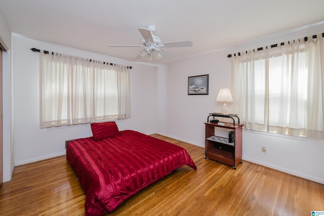 bedroom with hardwood / wood-style flooring and ceiling fan