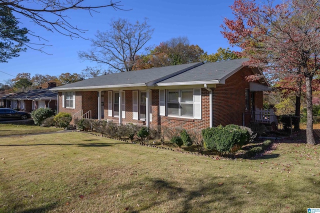 single story home with a porch and a front yard