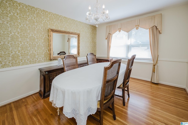 dining space featuring hardwood / wood-style floors and a notable chandelier