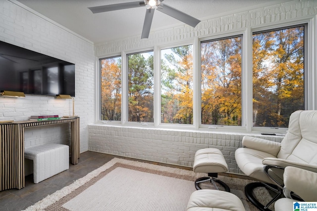 sunroom / solarium featuring ceiling fan