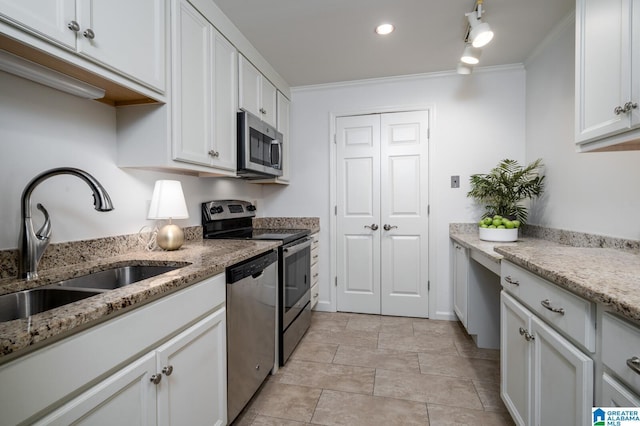 kitchen with light stone countertops, appliances with stainless steel finishes, ornamental molding, sink, and white cabinets