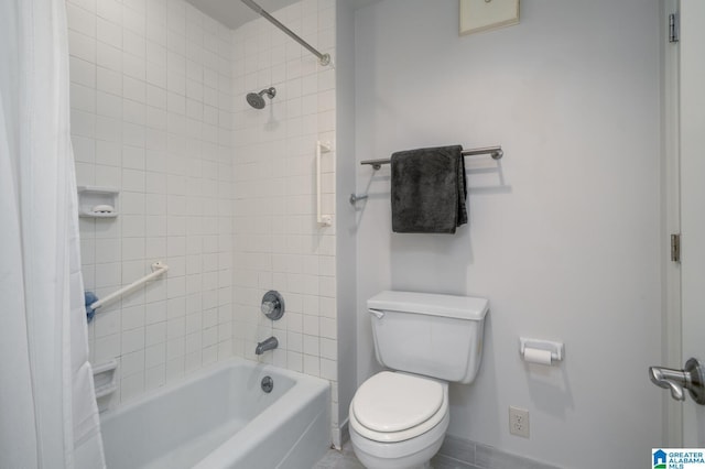 bathroom featuring tiled shower / bath combo and toilet