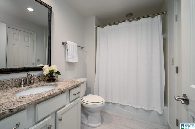 full bathroom featuring vanity, shower / bath combo, and toilet