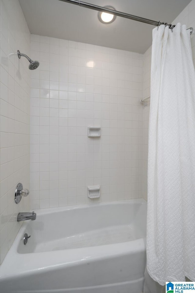 bathroom with shower / bath combo with shower curtain