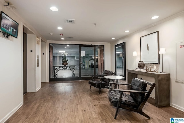 hallway with crown molding and wood-type flooring