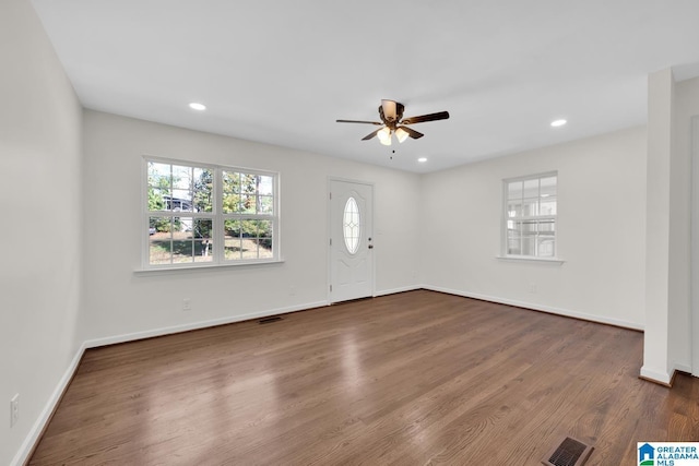 unfurnished room with dark hardwood / wood-style floors and ceiling fan