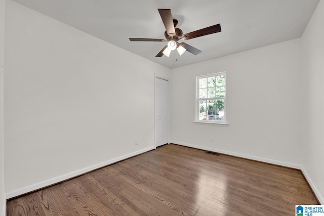 empty room featuring hardwood / wood-style floors and ceiling fan