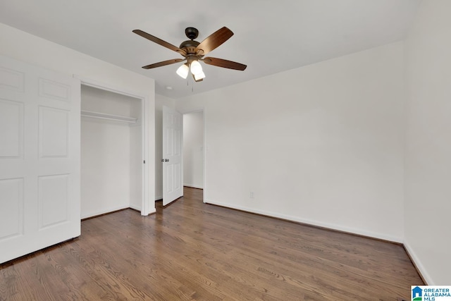 unfurnished bedroom with ceiling fan, a closet, and dark hardwood / wood-style floors