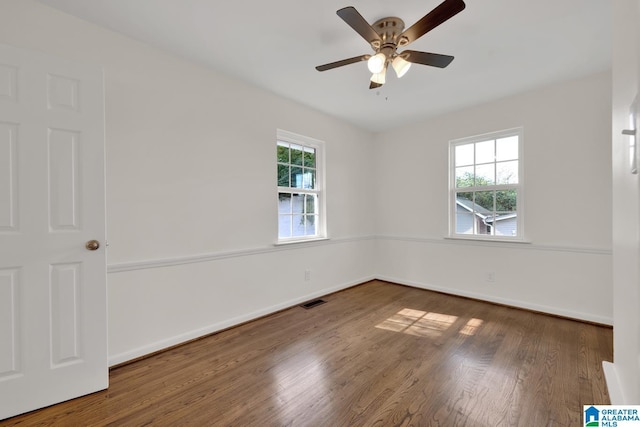 empty room featuring ceiling fan and dark wood-type flooring