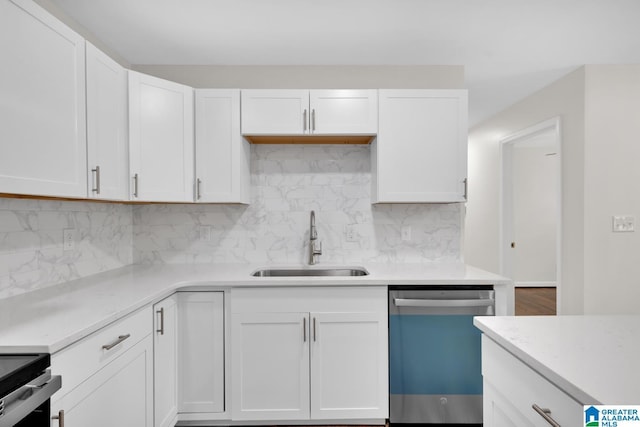 kitchen with white cabinets, decorative backsplash, stainless steel dishwasher, and sink