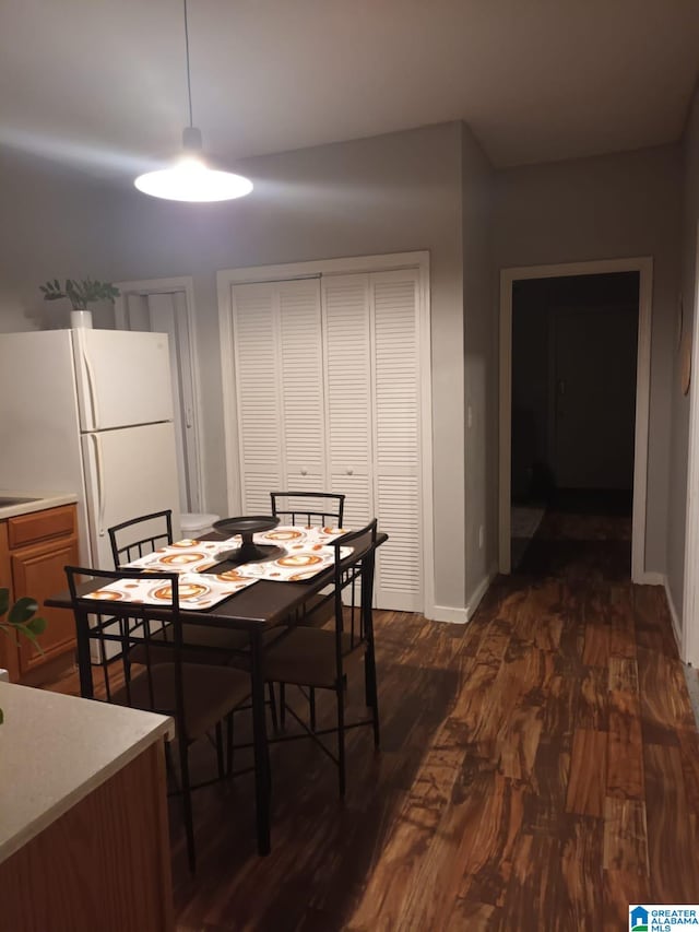 dining area with dark hardwood / wood-style floors