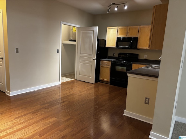 kitchen featuring sink, black appliances, and dark hardwood / wood-style floors