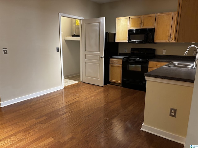 kitchen featuring wood-type flooring, sink, and black appliances