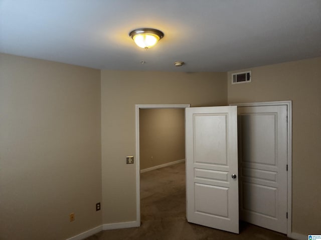 unfurnished bedroom with carpet flooring and a closet