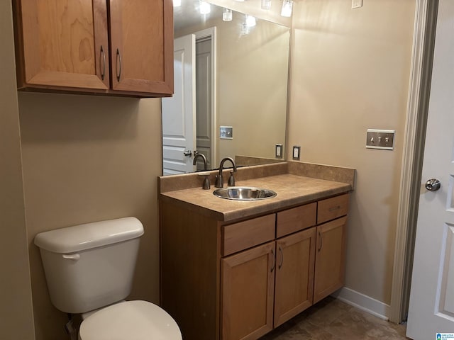 bathroom with tile patterned floors, vanity, and toilet