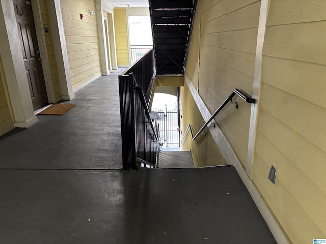 hallway with wood walls