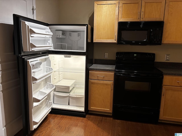 kitchen featuring hardwood / wood-style floors and black appliances