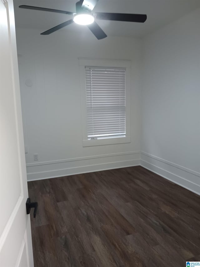 unfurnished room featuring ceiling fan and dark wood-type flooring