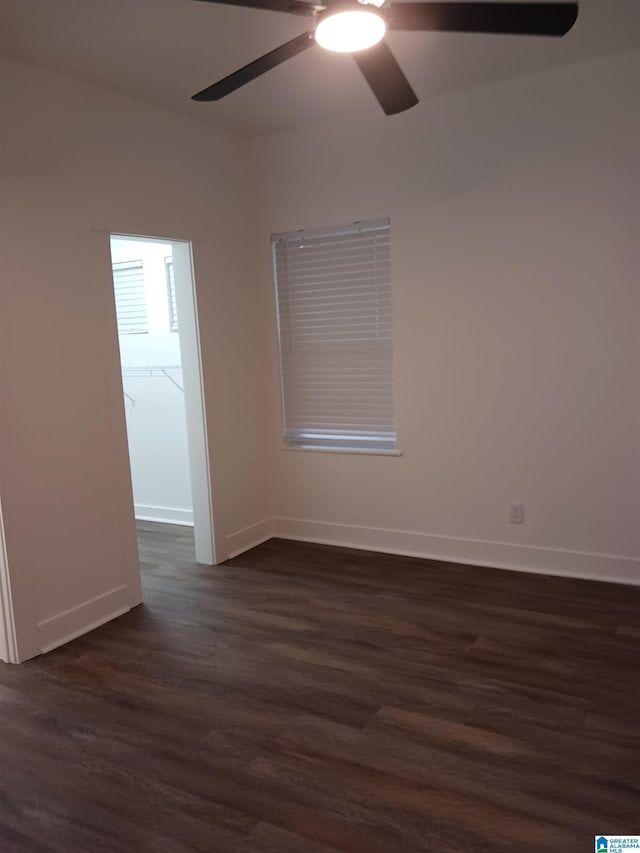 spare room with ceiling fan and dark hardwood / wood-style flooring